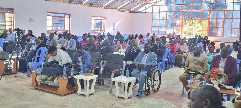 A hall full of seated conference attendees