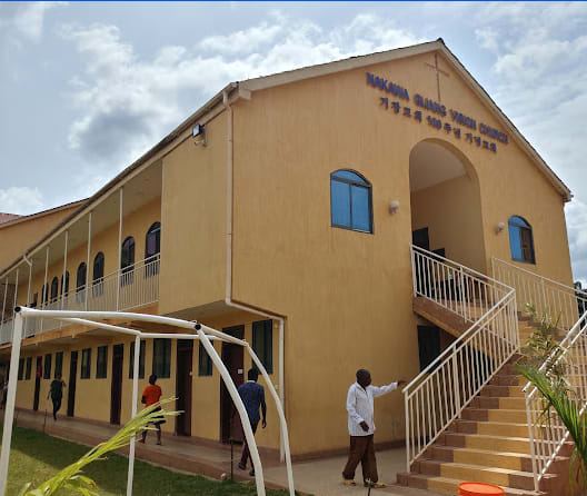 Two-storey yellow church building with an outside staircase