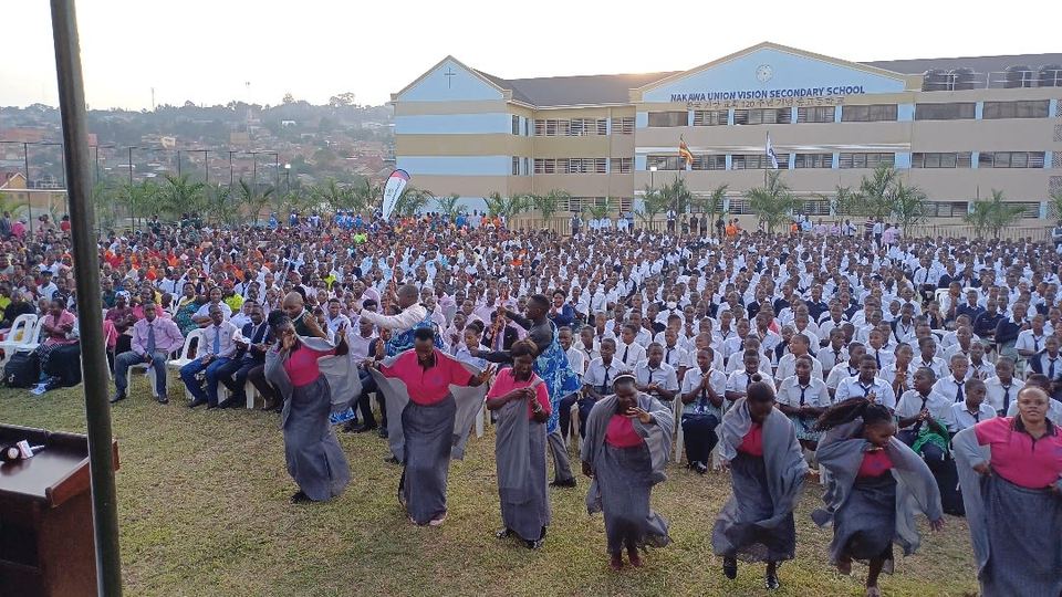 Students gathered on the school field in front of the secondary school building